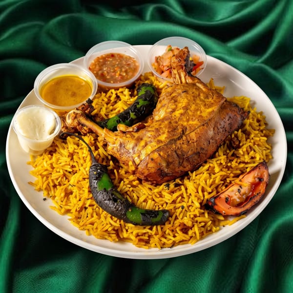 Roasted chicken leg and thigh on a bed of yellow rice with sauces, grilled peppers, and tomato.